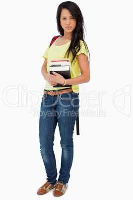 Pretty Latin student with backpack holding textbooks