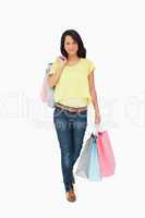 Beautiful Latin student walking with shopping bags