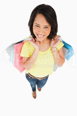 Fisheye view of a young woman holding shopping bags