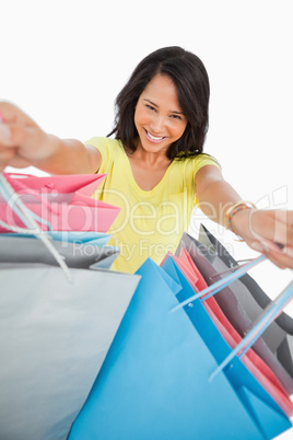 High-angle view of a young woman showing shopping bags