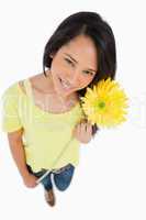 High-angle view of a Latino woman holding a flower