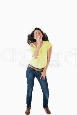 Young Latino student singing while shaking her head