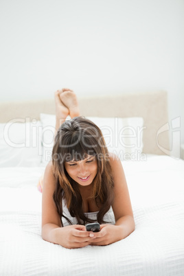 Smiling young woman using her cellphone