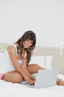 Portrait of a young woman chatting on her laptop