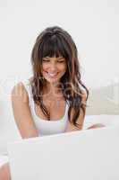 Attractive young woman chatting on her laptop