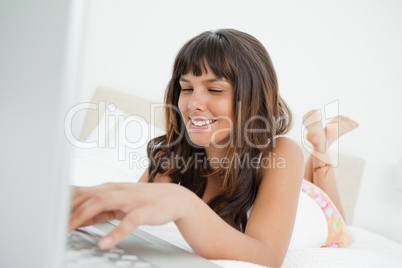 Smiling woman chatting on a laptop