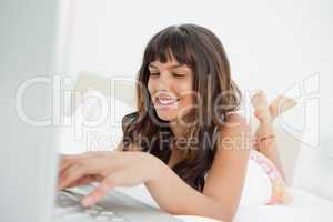Smiling woman chatting on a laptop