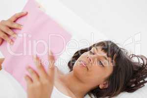 Angle shot of a young woman reading a book