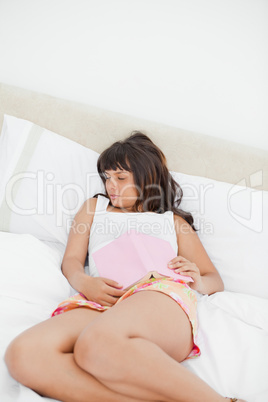 Student disheveled sleeping while holding a book