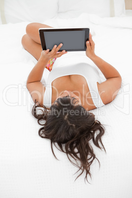 Rear view of a young woman using a touch pad