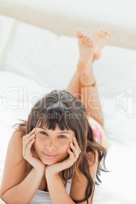 Portrait of a cute young woman on her bed