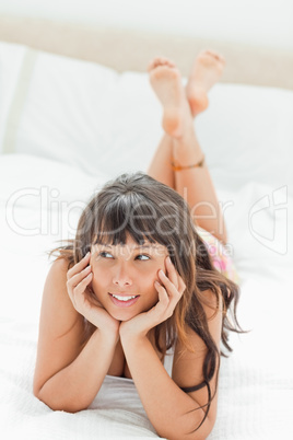 Beautiful young woman on her bed