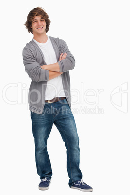 Smiling male student posing with crossed arms