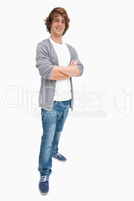 Smiling male student posing in jeans