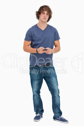 Handsome student holding a cellphone