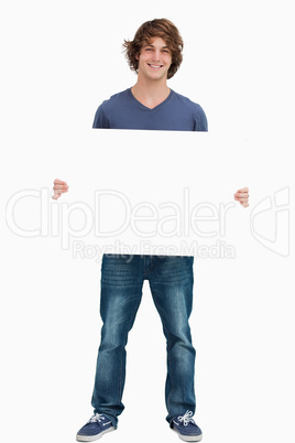 Male student holding a white board