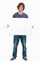 Male student holding a white board