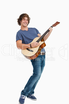 Male student posing while playing guitar