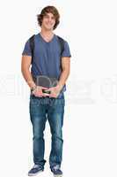 Male student posing with a backpack and books
