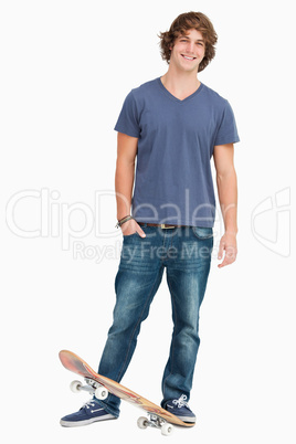 Smiling male student with a skateboard