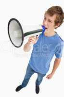 Fisheye view of a male student yelling in a loudspeaker