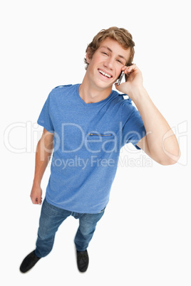 Fisheye view of a laughing male student on the phone
