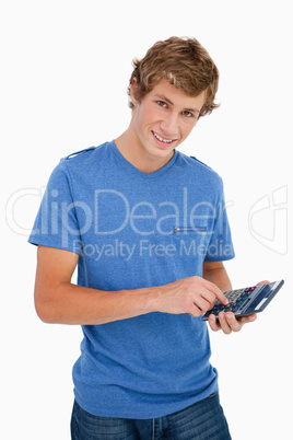 Portrait of a young man using a calculator
