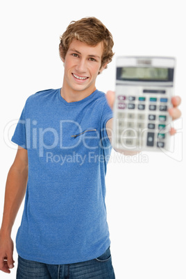 Smiling young man showing a calculator