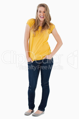 Smiling young woman posing hands in the pockets