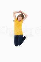 Young woman in yellow shirt jumping