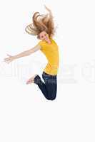 Blonde woman in yellow shirt jumping