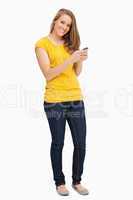 Attractive blonde woman posing while using her cellphone