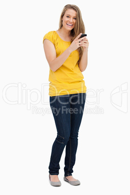 Portrait of a blonde woman laughing while using her cellphone