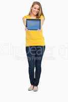 Blonde woman smiling while showing a touch pad screen