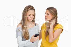 Upset young woman consoled by her friend