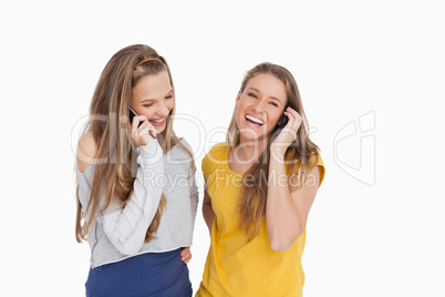 Two young women laughing on the phone