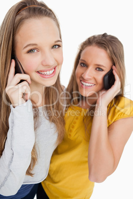Close-up of two students smiling on the phone