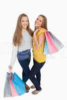 Two beautiful young women holding shopping bags
