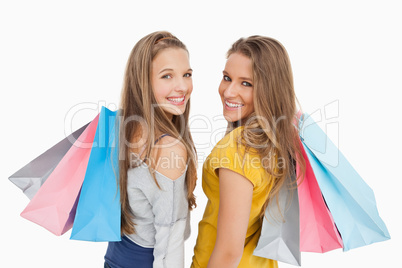 Two young women with shopping bags