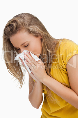 Close-up of a blond young woman blowing