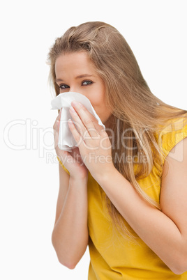 Portrait of a blond woman blowing