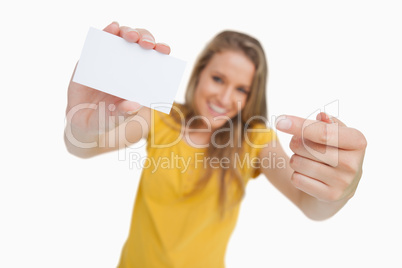 Close-up on a white card holding by a blonde student