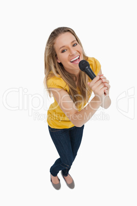 Fisheye view of blonde singing with a microphone