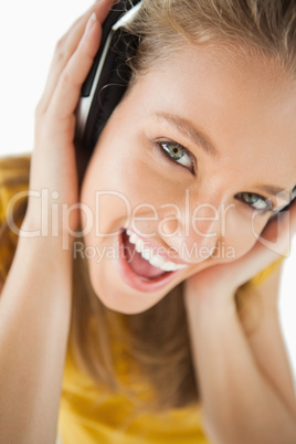 Close-up of a blonde girl enjoying music with headphones