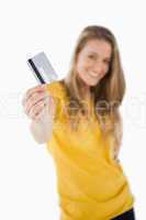 Portrait of a blonde student tending a credit card