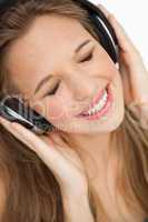 Close-up of a cute young blonde listening to music