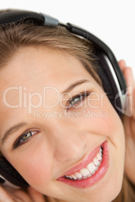 Close-up of a green-eyes woman listening to music