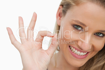 Close-up of a young woman gesturing to approve
