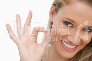 Close-up of a young woman gesturing to approve