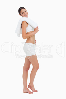 Side view of a slim woman holding a towel